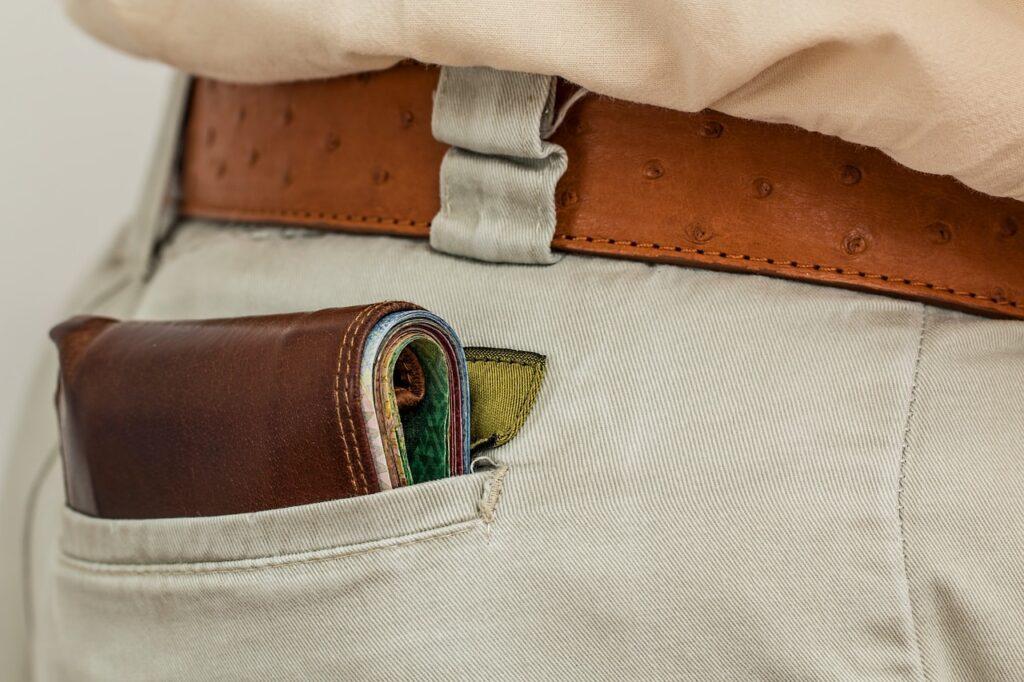 Wallet filled with cash in back pocket