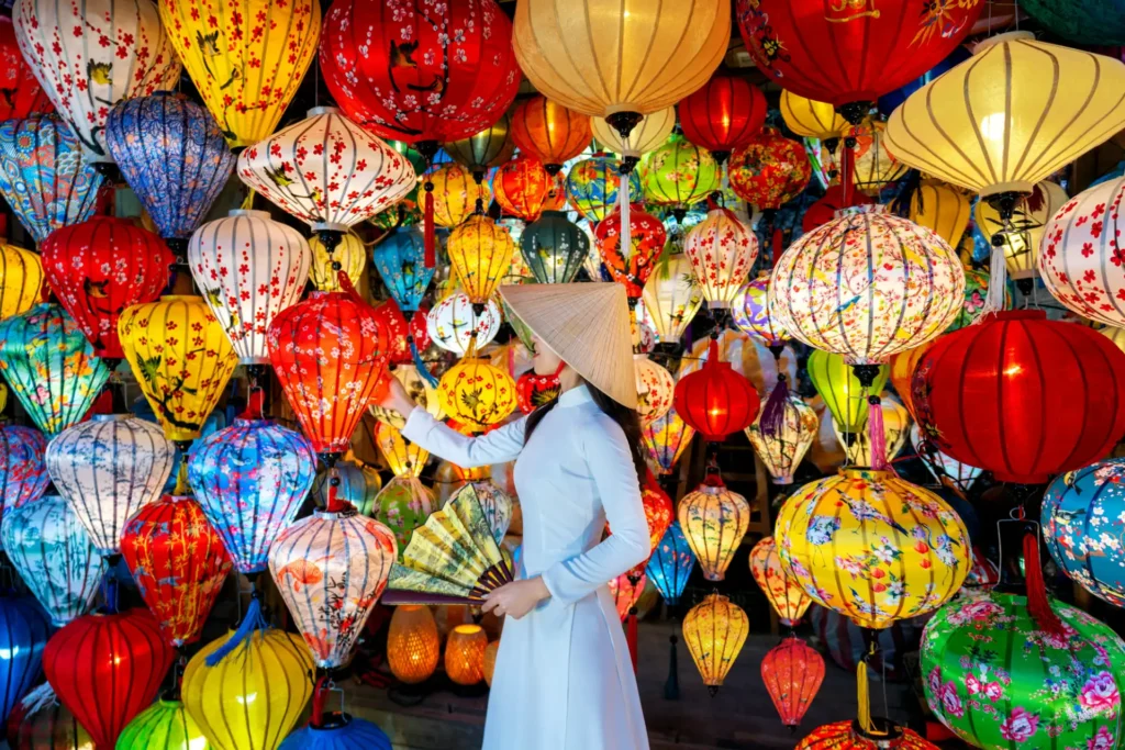 Asian woman wearing vietnam culture traditional and hoi an lanterns at Hoi An ancient town, Vietnam.